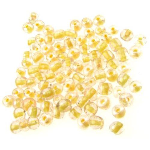 Γυάλινες χάντρες seed 4 mm διαφανές με βασή λαμπερό κίτρινο -50 γραμμάρια