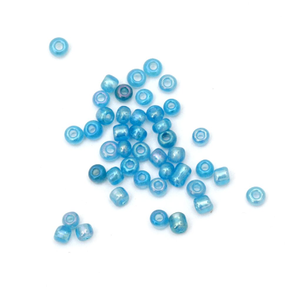 Γυάλινες χάντρες seed 3 mm διαφανές με μπλε -50 γραμμάρια