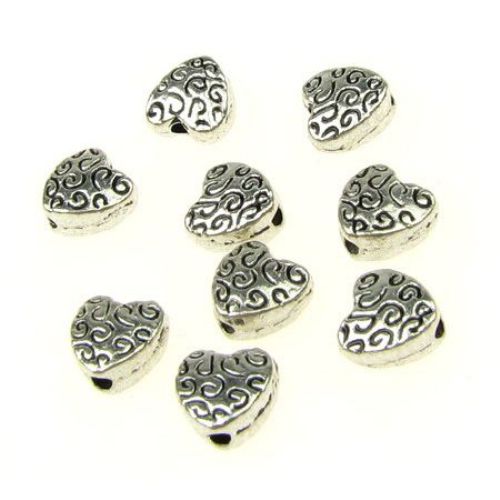 Metal heart shaped bead, embossed with curved ornaments 6x6x3 mm hole 1 mm color silver - 30 pieces
