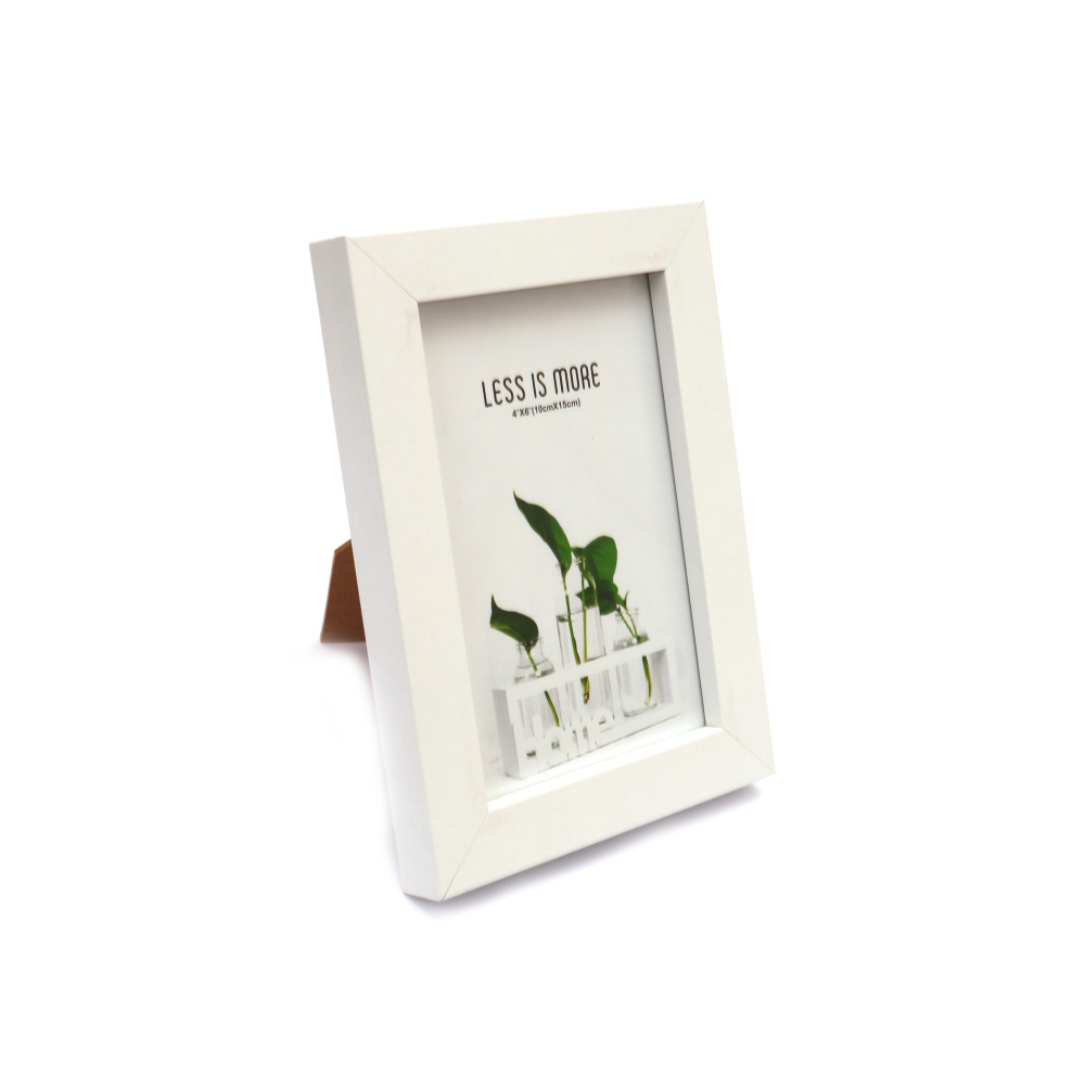 A white photo frame for a 10x15 cm picture. Display your cherished memories with this elegant and simple frame that complements any decor. Get yours today at a great price!