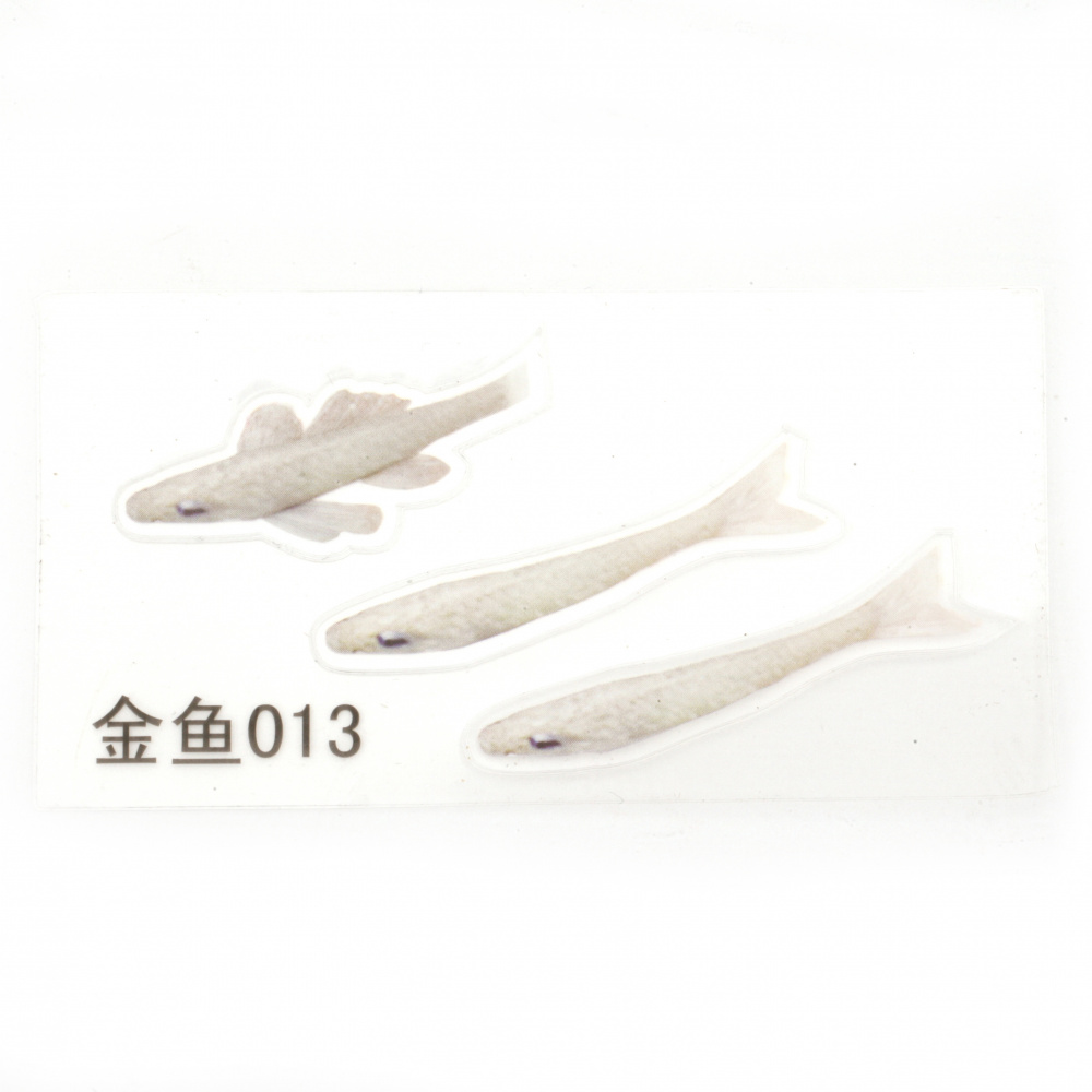 Self-adhesive sticker for embedding in epoxy resin to create a hand-painted 3D effect with layering, featuring a small golden fish, with an image size of 42x13 mm
