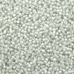 Γυάλινες χάντρες seed  3 mm διαφανείς  γυαλιστερό με λευκή βασή -50 γραμμάρια