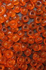 Γυάλινες χάντρες seed 3 mm διαφανές σκούρο πορτοκαλί -50 γραμμάρια