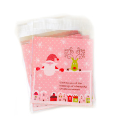 Plic de celofan 10x13 cm Moș Crăciun și Rudolf culoare transparentă cu spate roz cu buline albe și adeziv - 100 bucăți