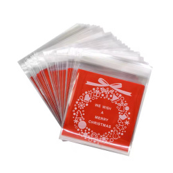 Plic de celofan 10x13 cm coroană de Crăciun transparentă cu spate roșu și adeziv - 100 bucăți